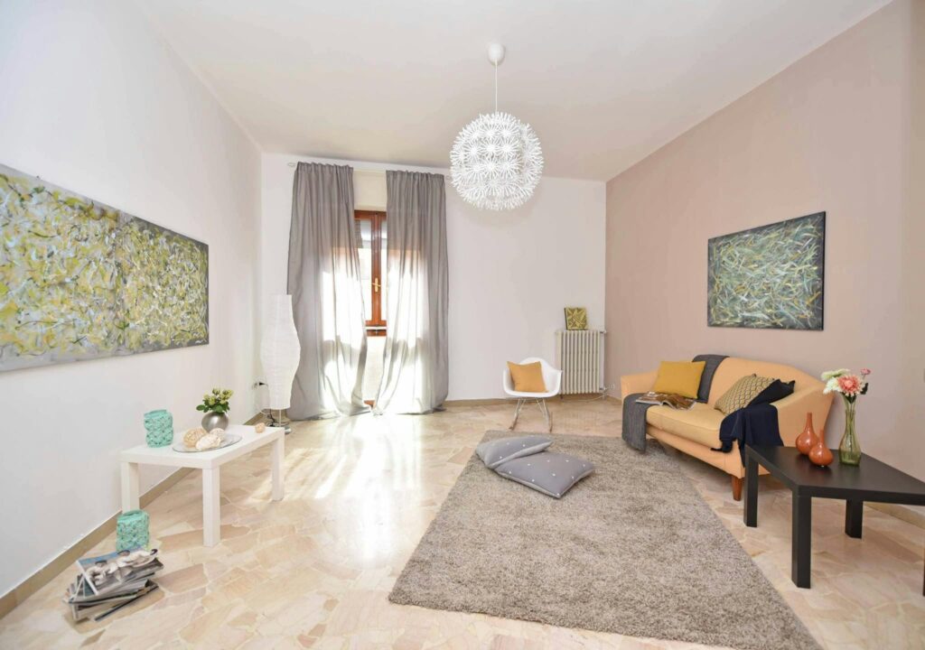 A spacious, modern living room with stylish decor and abundant natural light from large windows.